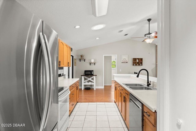2455 Whooping Crane Dr, Deleon Springs, FL 32130 - kitchen featuring appliances with stainless steel finishes, vaulted ceiling, light countertops, light tile patterned floors, and a ceiling fan