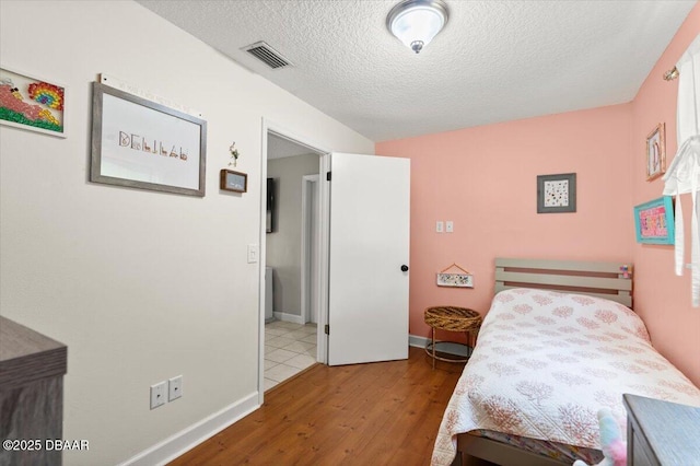 2455 Whooping Crane Dr, Deleon Springs, FL 32130 - bedroom featuring wood finished floors and a textured ceiling