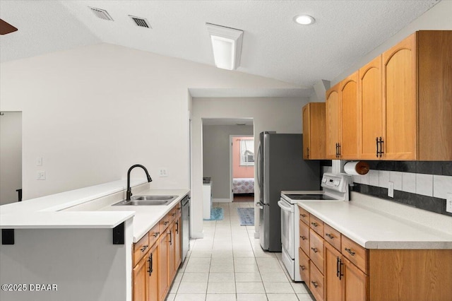 2455 Whooping Crane Dr, Deleon Springs, FL 32130 - kitchen featuring electric range, lofted ceiling, light tile patterned floors, stainless steel dishwasher, and light countertops