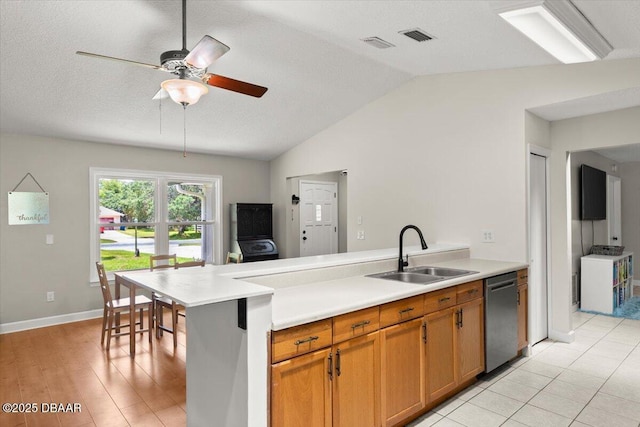 2455 Whooping Crane Dr, Deleon Springs, FL 32130 - kitchen with stainless steel dishwasher, a peninsula, light countertops, lofted ceiling, and a ceiling fan