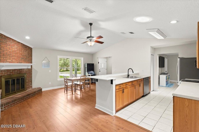 2455 Whooping Crane Dr, Deleon Springs, FL 32130 - kitchen with freestanding refrigerator, vaulted ceiling, light countertops, ceiling fan, and stainless steel dishwasher