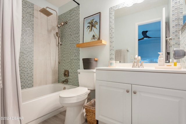 full bathroom featuring tiled shower / bath, hardwood / wood-style flooring, toilet, and vanity