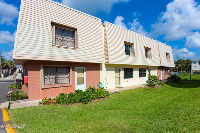 rear view of property featuring a yard