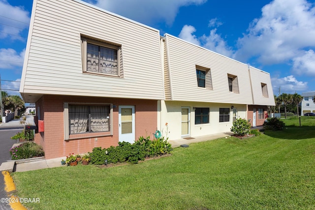 3750 S Atlantic Ave Unit 180, Daytona Beach Shores, FL 32118 - townhome / multi-family property with brick siding and a front lawn