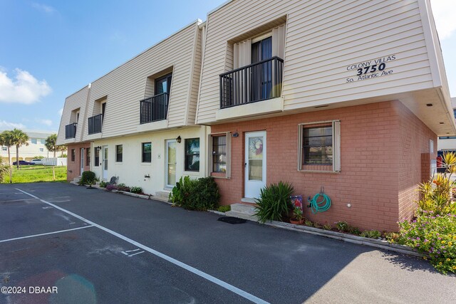 3750 S Atlantic Ave Unit 180, Daytona Beach Shores, FL 32118 - view of property with uncovered parking and entry steps