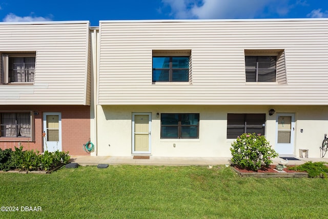 3750 S Atlantic Ave Unit 180, Daytona Beach Shores, FL 32118 - rear view of house with a lawn and brick siding