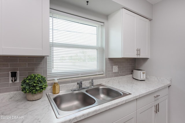 3750 S Atlantic Ave Unit 180, Daytona Beach Shores, FL 32118 - kitchen with a sink, white cabinets, tasteful backsplash, and light countertops