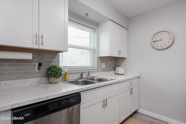 3750 S Atlantic Ave Unit 180, Daytona Beach Shores, FL 32118 - kitchen featuring stainless steel dishwasher, a sink, white cabinets, and light countertops