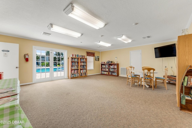 4590 S Atlantic Ave Unit 244A, Ponce Inlet, FL 32127 - sitting room with light carpet, a textured ceiling, and crown molding