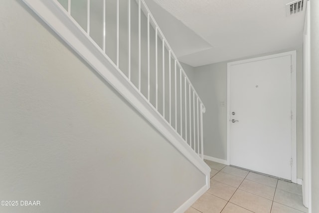 4590 S Atlantic Ave Unit 244A, Ponce Inlet, FL 32127 - entryway with stairs and light tile patterned flooring