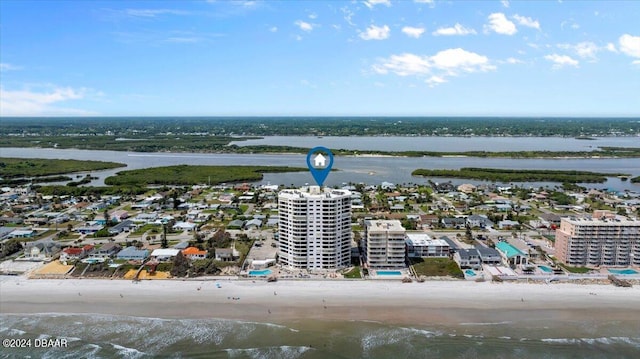 birds eye view of property with a view of the beach and a water view