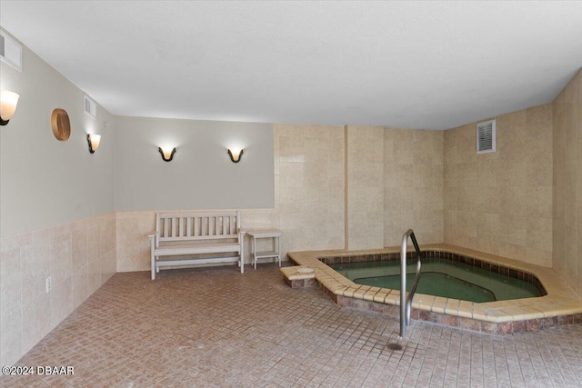 view of pool with an indoor hot tub