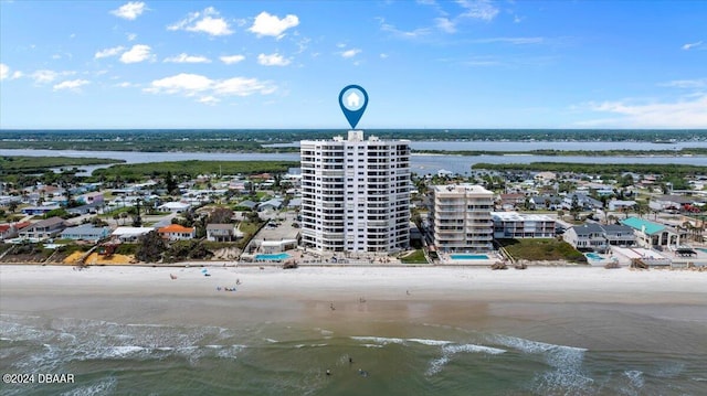 drone / aerial view with a beach view and a water view