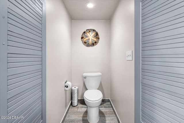 bathroom with hardwood / wood-style flooring and toilet