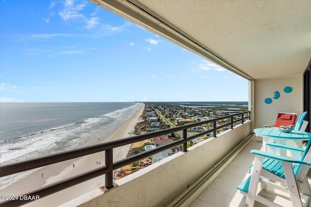 balcony with a view of the beach and a water view