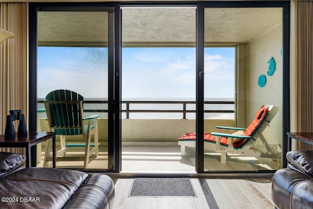 living room featuring a water view and wood-type flooring