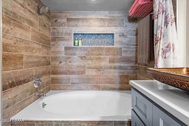 bathroom featuring shower / tub combo with curtain, vanity, and a textured ceiling