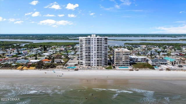 drone / aerial view featuring a view of the beach and a water view