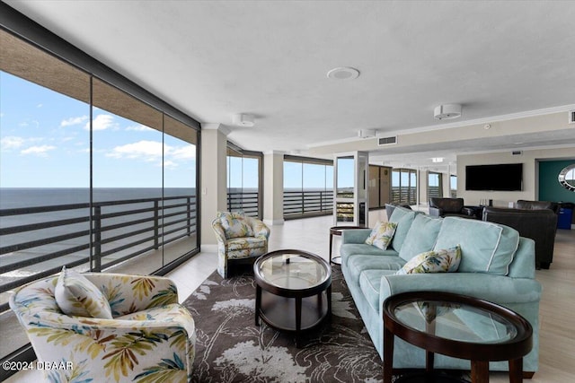 living room featuring light hardwood / wood-style floors, a water view, and floor to ceiling windows