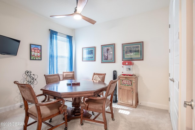 dining space with light colored carpet and ceiling fan