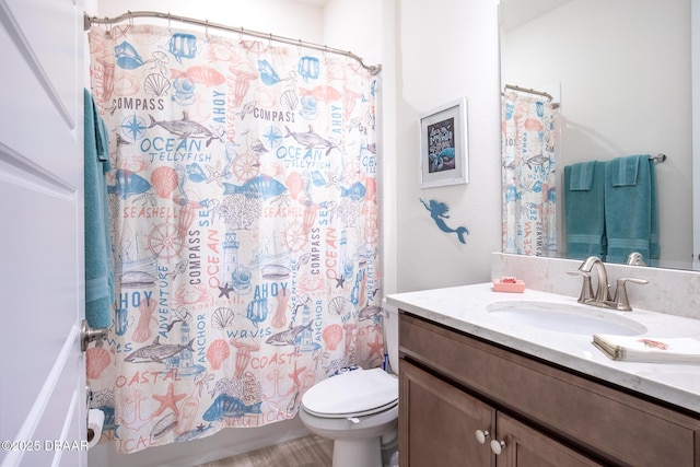 full bathroom featuring shower / tub combo with curtain, vanity, and toilet