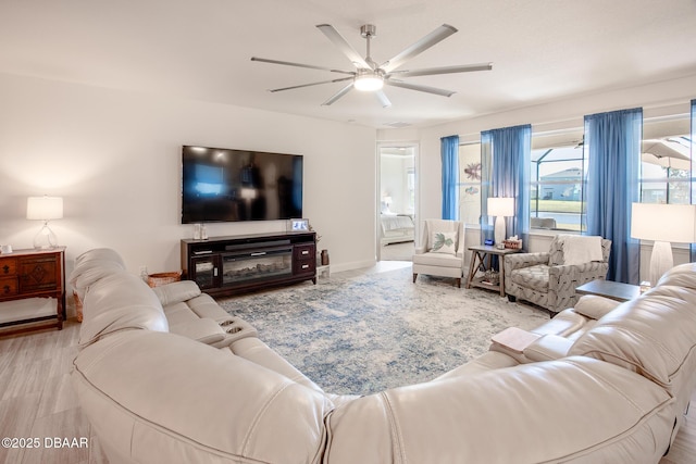 living room featuring ceiling fan and light hardwood / wood-style floors