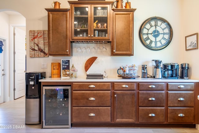 bar featuring beverage cooler and light hardwood / wood-style floors