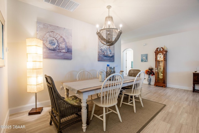 dining area with a notable chandelier and light wood-type flooring