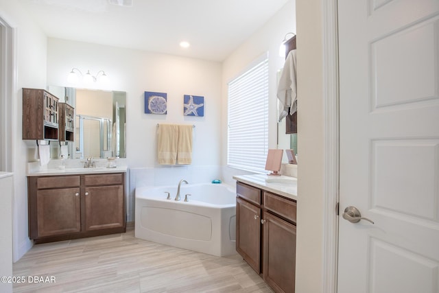 bathroom with vanity and a bathtub