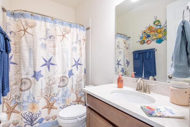 bathroom with vanity, a shower with shower curtain, and toilet