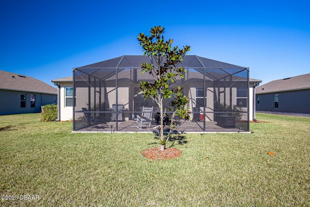 back of house featuring a patio, a lanai, and a lawn