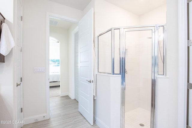 bathroom with hardwood / wood-style floors and walk in shower