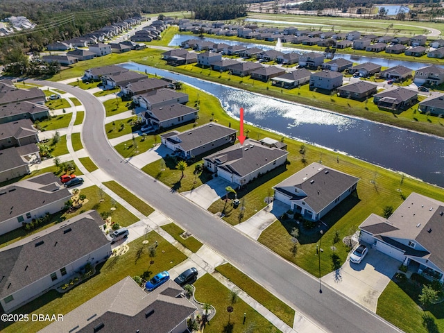 birds eye view of property with a water view