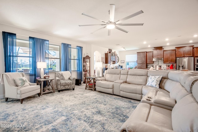 living room with ceiling fan and light carpet