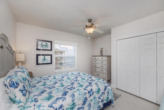 3721 S Atlantic Ave Unit 1101, Daytona Beach Shores, FL 32118 - tiled bedroom with a closet, ceiling fan, and a textured ceiling