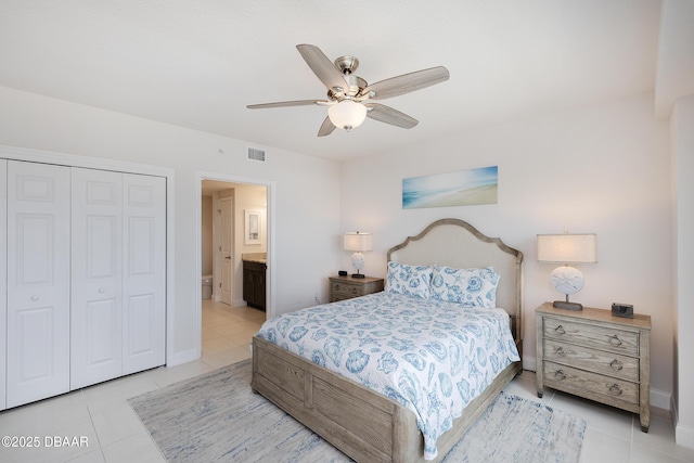 3721 S Atlantic Ave Unit 1101, Daytona Beach Shores, FL 32118 - bedroom with light tile patterned floors, a closet, a ceiling fan, and ensuite bath