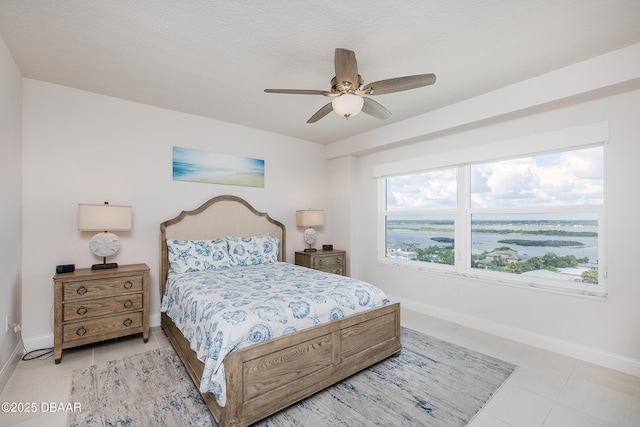 3721 S Atlantic Ave Unit 1101, Daytona Beach Shores, FL 32118 - bedroom with light tile patterned floors and ceiling fan