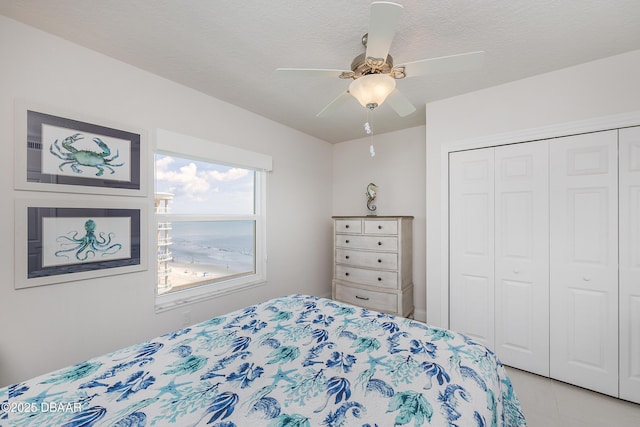 3721 S Atlantic Ave Unit 1101, Daytona Beach Shores, FL 32118 - bedroom with a closet, a ceiling fan, and a textured ceiling