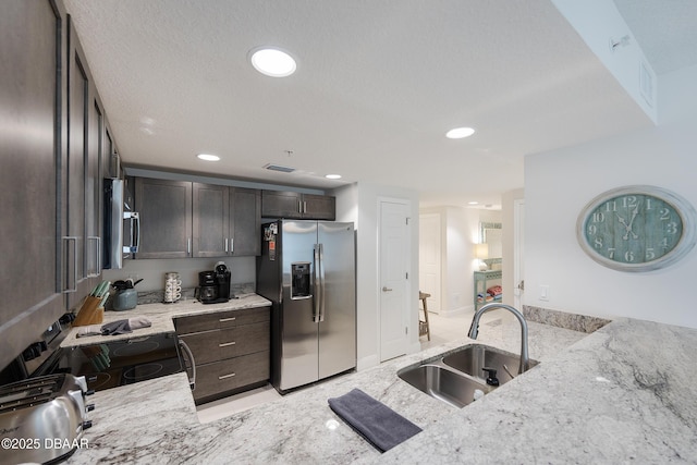 3721 S Atlantic Ave Unit 1101, Daytona Beach Shores, FL 32118 - kitchen featuring appliances with stainless steel finishes, dark brown cabinetry, light stone countertops, and recessed lighting