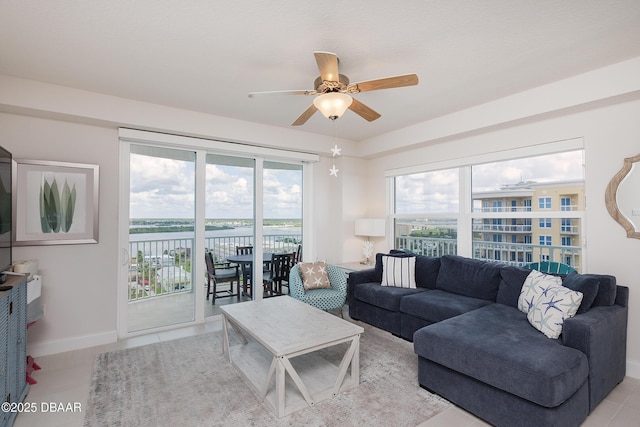 3721 S Atlantic Ave Unit 1101, Daytona Beach Shores, FL 32118 - living room featuring a water view, ceiling fan, and light tile patterned flooring