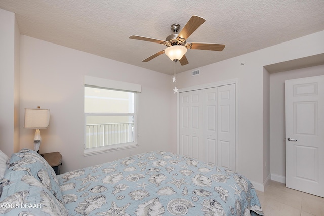 3721 S Atlantic Ave Unit 1101, Daytona Beach Shores, FL 32118 - bedroom with a closet, a textured ceiling, ceiling fan, and light tile patterned floors