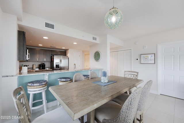 3721 S Atlantic Ave Unit 1101, Daytona Beach Shores, FL 32118 - dining space with light tile patterned floors and recessed lighting
