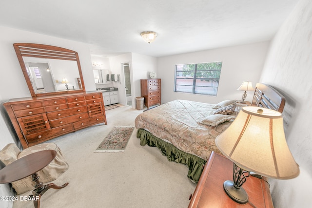 carpeted bedroom featuring ensuite bath