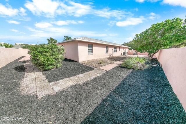 110 Ponce Terrace Cir, Ponce Inlet, FL 32127 - rear view of property with a fenced backyard and stucco siding