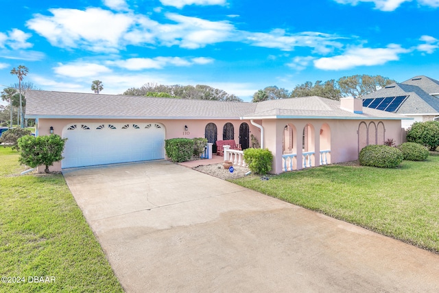 single story home with a front yard and a garage