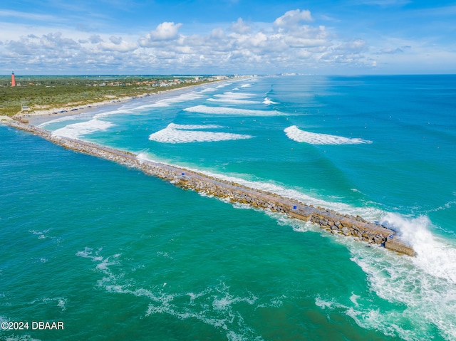 bird's eye view featuring a water view and a beach view