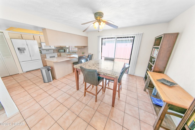 dining area featuring ceiling fan, light tile patterned floors, and a textured ceiling