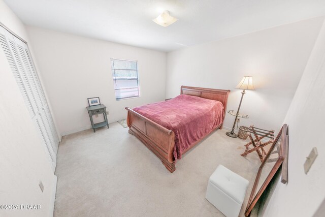 110 Ponce Terrace Cir, Ponce Inlet, FL 32127 - bedroom with light colored carpet and a closet