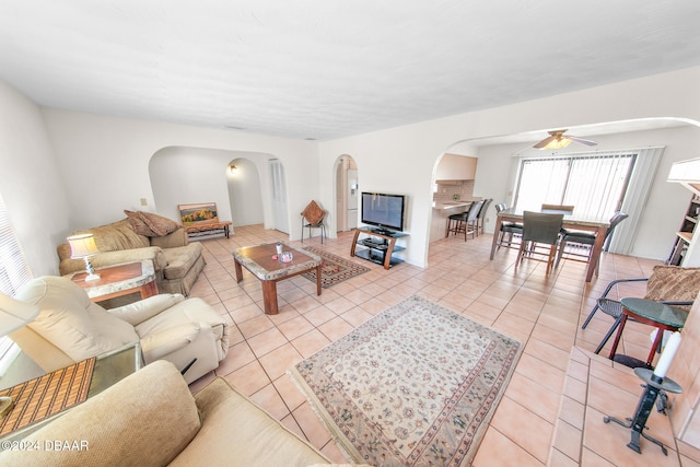 living room featuring ceiling fan and light tile patterned floors