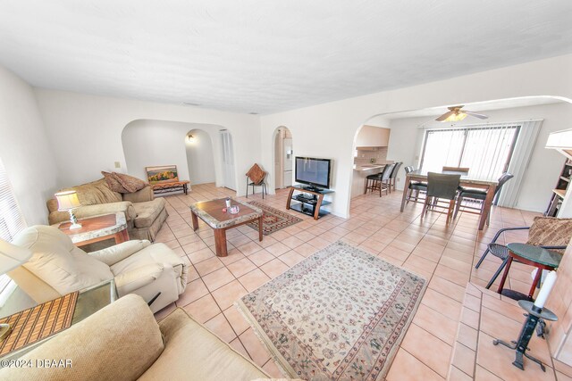 110 Ponce Terrace Cir, Ponce Inlet, FL 32127 - living room featuring arched walkways, a ceiling fan, and light tile patterned flooring